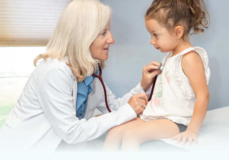 Physician listening to a young girl's heartbeat with a stethoscope during an allergy evaluation