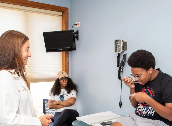 Allergist talking with a family during an oral immunotherapy visit